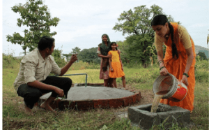 a lady is engaged in the biogas plant that the family watching