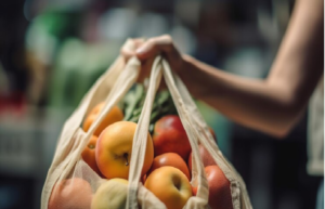 a lady holding apples in a reusable produce bag 
