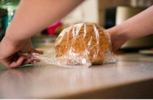 a bread is being wrapped in reusable plastic. 