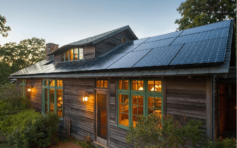 A lighted house with solar panels installed