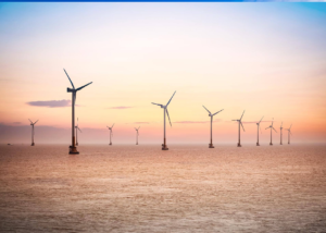 A picturesque view of wind turbines in the ocean, symbolizing wind energy.